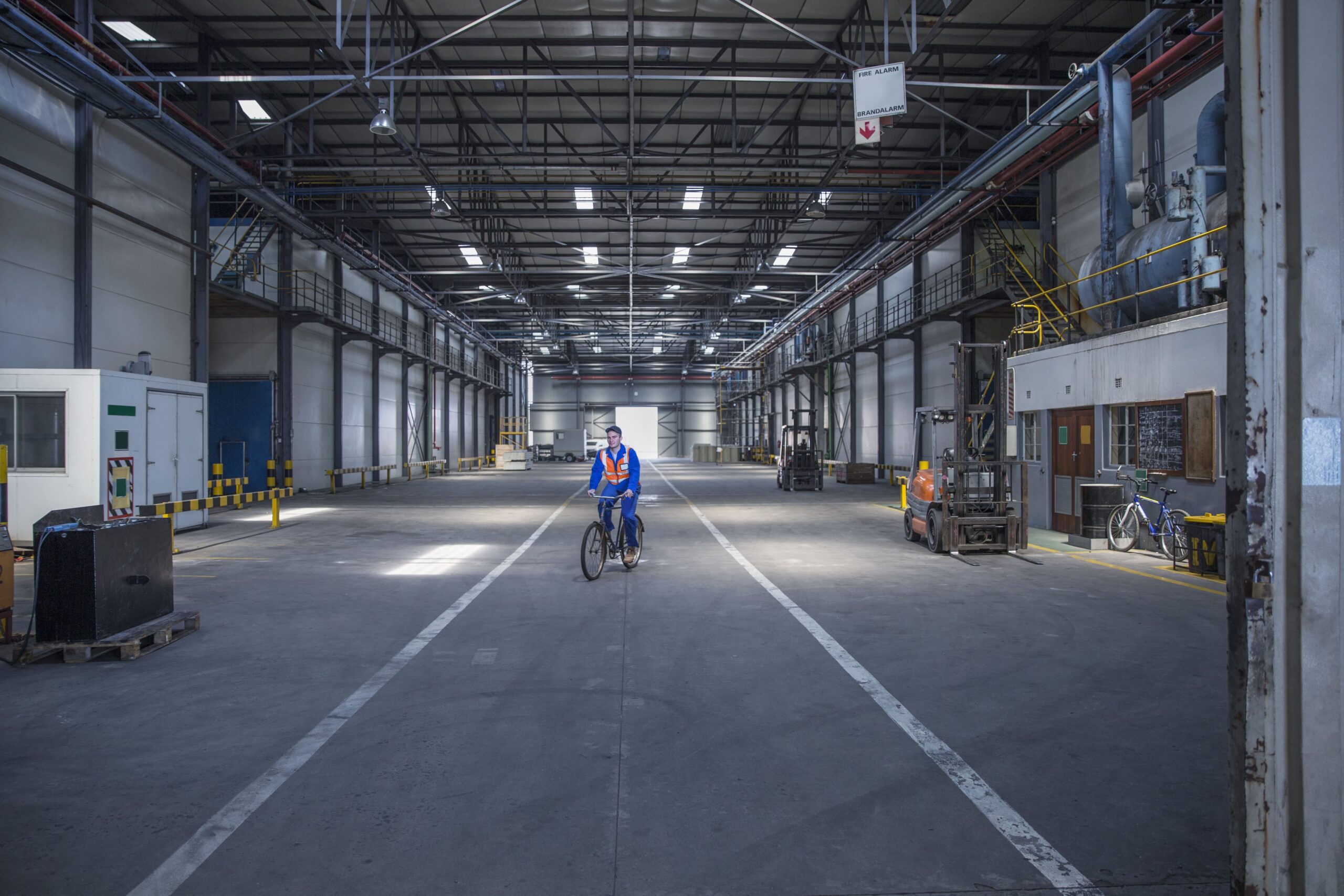 worker-on-bicycle-in-warehouse-2024-09-18-21-16-29-utc (1)